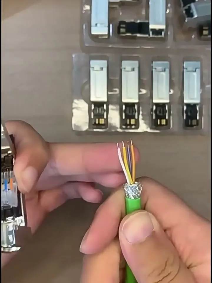 The prepared cable end: jacket removed, braid shield folded back, four insulated conductors fanned out.