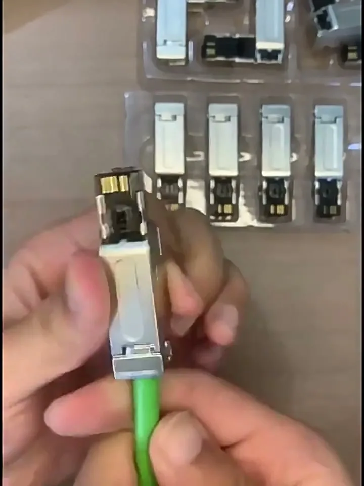 The nickel-plated shell closed around the contact block, with the cable clamped.