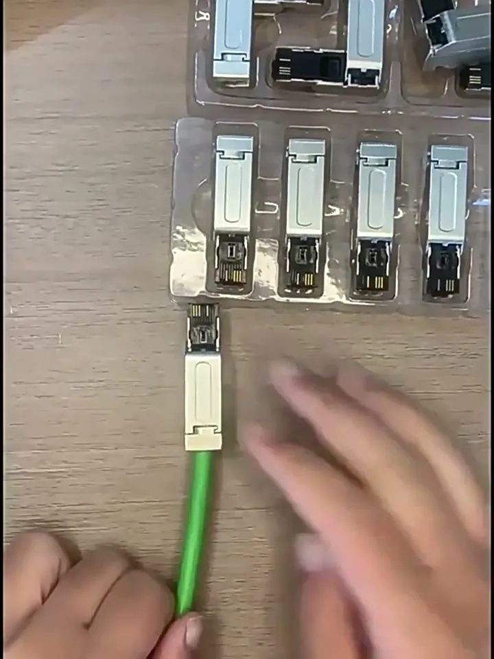 The finished shielded RJ45 field-wireable connector on a green industrial Ethernet cable.