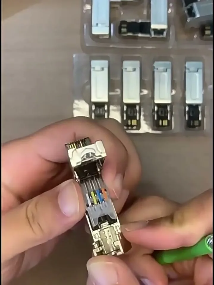 The four conductors laid into the contact block channels, colours visible.